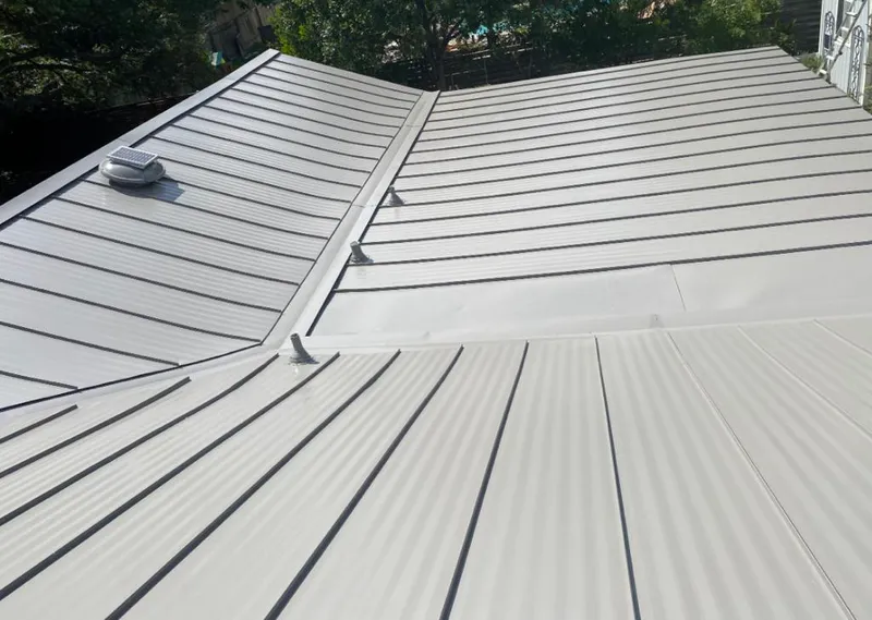 Solar attic fan installed on a metal roof for Roof Ventilation in Omak